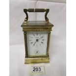 A brass 'Angelus' carriage alarm clock with key.