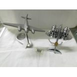 An art deco condiment set as a plane and a white metal plane desk stand.