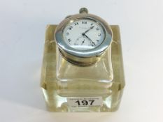 A glass inkwell with silver topped pocket watch holder incorporating a steel cased watch,