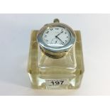 A glass inkwell with silver topped pocket watch holder incorporating a steel cased watch,