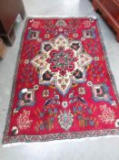A small red rug, 56 x 36 inches.
