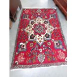 A small red rug, 56 x 36 inches.