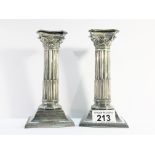 A pair of silver plated Corinthian column candlesticks.