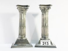 A pair of silver plated Corinthian column candlesticks.