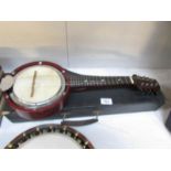 A model XXS 8 string banjo with case.