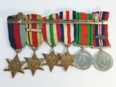 A set of 6 WW2 medals with ribbons and bar including one 'Mentioned in Dispatch' bar.