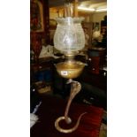 A brass oil lamp in the form of a cobra snake