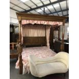 A superb quality four poster bed with carved post and linen carved headboard.