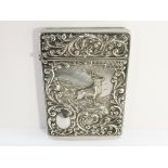 An embossed silver card case depicting a stag, hall marked C & N, Birmingham 1902.