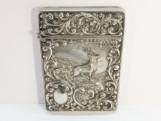 An embossed silver card case depicting a stag, hall marked C & N, Birmingham 1902.