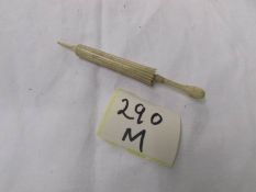 A bone stanhope needle case in the form of an umbrella.