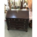 A Georgian mahogany bureau with 5 drawers and fitted interior.