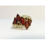 A 9ct gold ring set red and white stones, size M.