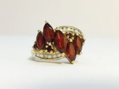 A 9ct gold ring set red and white stones, size M.