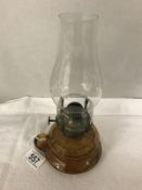 An amber glass hand oil lamp.