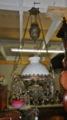 A Victorian all brass hanging lamp with counter balance, thumb cut glass vessel, twin wick burner,