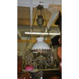 A Victorian all brass hanging lamp with counter balance, thumb cut glass vessel, twin wick burner,