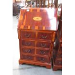 A small mahogany inlaid bureau with 4 drawers.