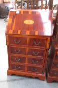 A small mahogany inlaid bureau with 4 drawers.
