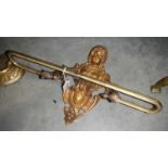An ornate brass towel rail in the form of a French Victorian lady.