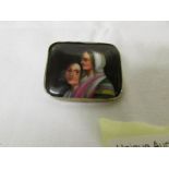A hand painted porcelain brooch with 2 ladies.