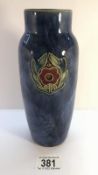 A Royal Doulton small vase with mottled blue ground and a simple motif of flower with leaves on