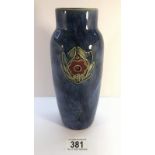 A Royal Doulton small vase with mottled blue ground and a simple motif of flower with leaves on