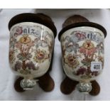 A pair of Wall mounting continental pottery salt pots on wooden backs.