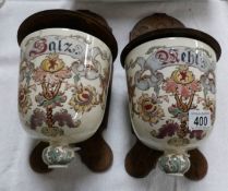 A pair of Wall mounting continental pottery salt pots on wooden backs.