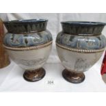 A pair of Doulton Lambeth 1882 Hannah Barlow vases with patterned top and bottom and incised