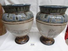 A pair of Doulton Lambeth 1882 Hannah Barlow vases with patterned top and bottom and incised