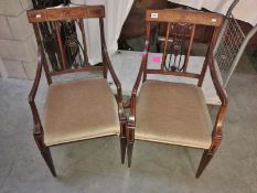 A pair of mahogany inlaid chairs.