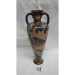 An exquisite Doulton Lambeth vase with narrow neck and 2 handles to body tapering to the base.