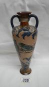 An exquisite Doulton Lambeth vase with narrow neck and 2 handles to body tapering to the base.