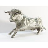 A silver model of a bull.
