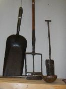 A collection of early tools including shovels, ladle etc.