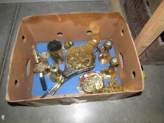 A box of assorted brass ware including bellows, candlesticks etc.