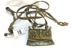 An antique metal and brass purse on leather straps.