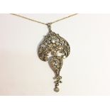 An approximately 2 carat old cut diamond floral pendant.