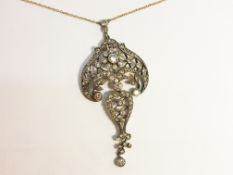 An approximately 2 carat old cut diamond floral pendant.