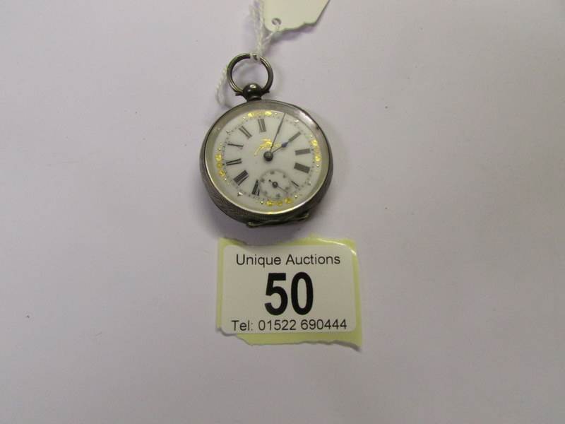 A ladies silver fob watch, in working order.