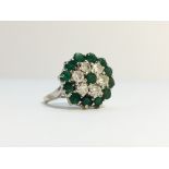 An 18ct gold emerald and diamond cluster ring, hall marked London 1972 (three quarter carat),