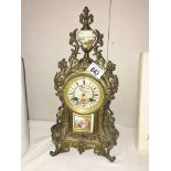 A French ormolu mantel clock with enamel dial and porcelain inset.