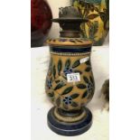 An attractive floral Doulton oil lamp with bank of white dots round the base and rim.