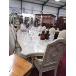 A large extending dining table with 2 leaves and 10 matching chairs.