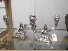 A pair of sterling silver candelabra.