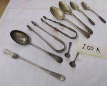 2 early silver sugar nips and assorted silver cutlery.