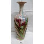 A large Doulton Burslem vase with lustrous pinkish white ground painted with red irises and leaves.