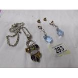 A gemstone pendant set with amethyst, peridot,