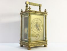 A Victorian brass carriage alarm clock with key.